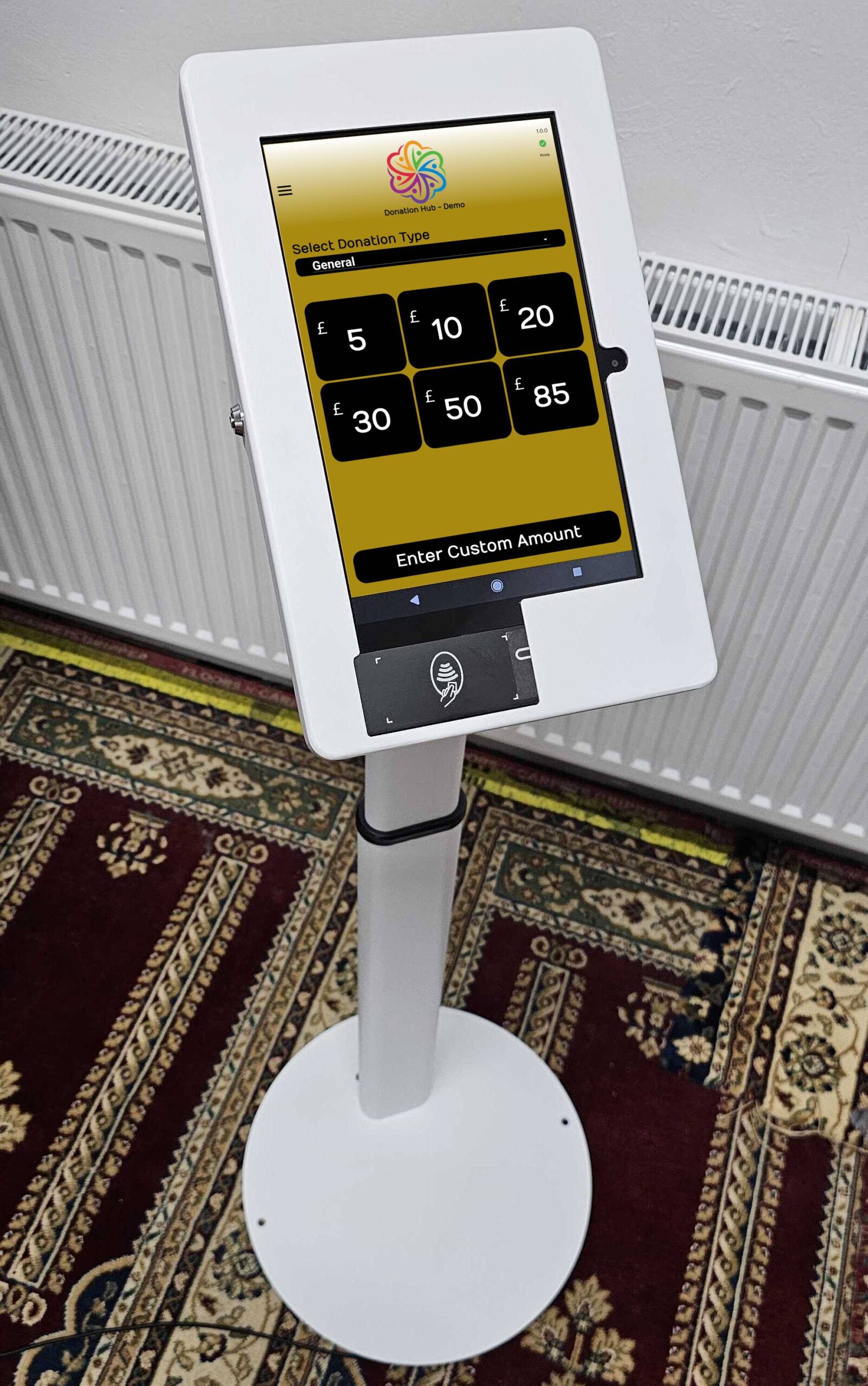 A Donation Hub tablet mounted on a floor stand