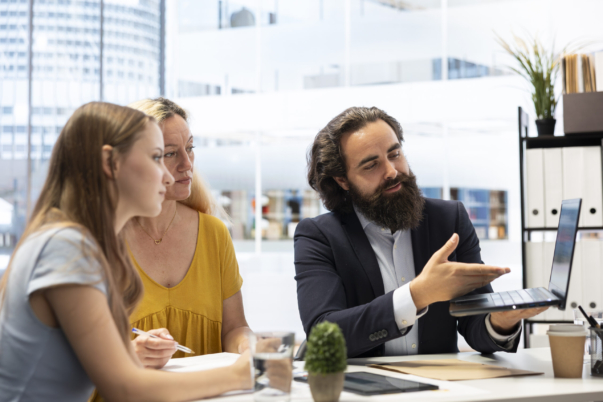 Financial advisor using laptop device to help family build and maintain healthy budget, avoiding overspending. Agent in office using software on notebook to build emergency fund plan for clients