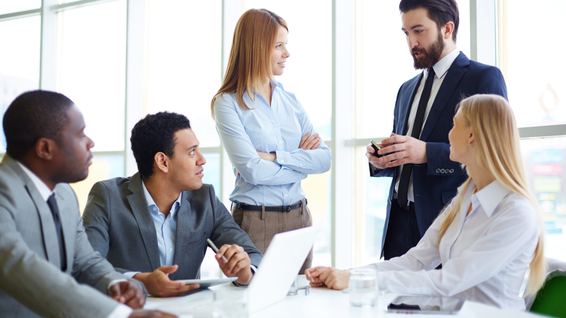 Group of business partners discussing ideas at meeting in office