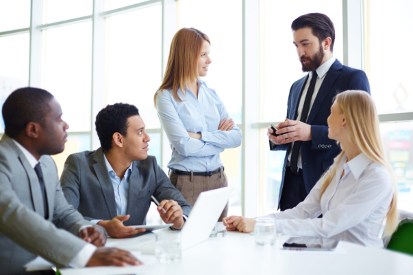 Group of business partners discussing ideas at meeting in office